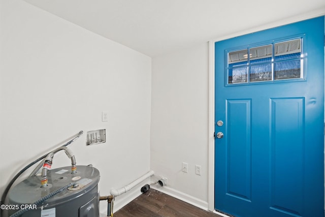 washroom with water heater, dark hardwood / wood-style flooring, and hookup for a washing machine