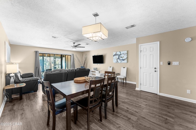 dining space featuring ceiling fan, dark hardwood / wood-style flooring, and a textured ceiling