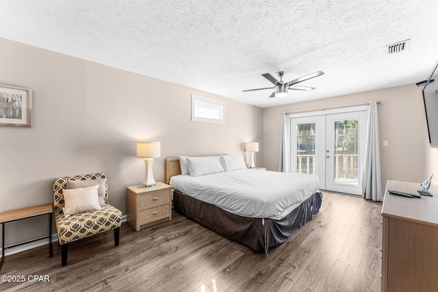 bedroom featuring ceiling fan, access to exterior, light hardwood / wood-style floors, and french doors