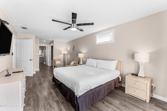 bedroom with ceiling fan and dark wood-type flooring