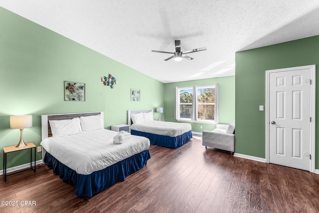 bedroom featuring ceiling fan, dark hardwood / wood-style flooring, and a textured ceiling