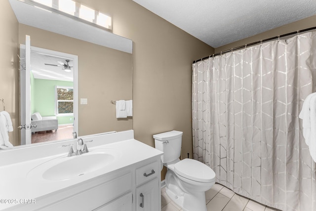 bathroom featuring toilet, ceiling fan, tile patterned floors, a textured ceiling, and vanity