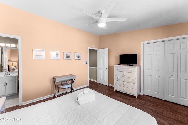 bedroom with ceiling fan, connected bathroom, a closet, dark hardwood / wood-style flooring, and sink