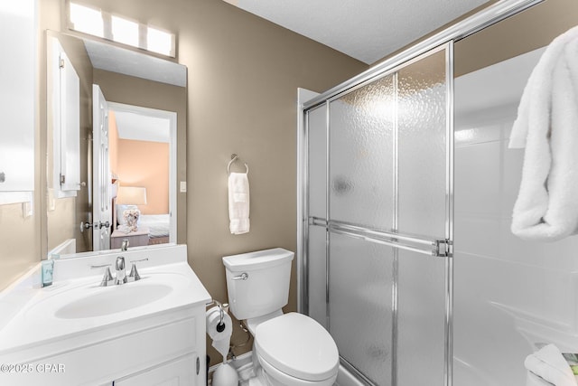 bathroom with toilet, a textured ceiling, walk in shower, and vanity