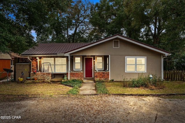 view of front of house featuring a storage unit