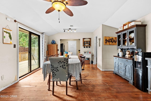 dining space featuring hardwood / wood-style floors, lofted ceiling, and ceiling fan