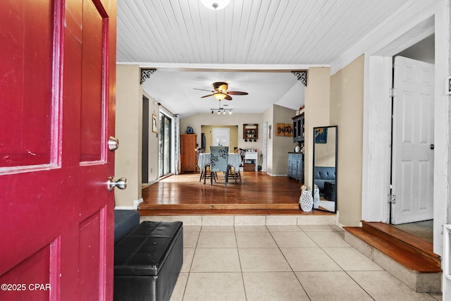 tiled foyer featuring lofted ceiling and ceiling fan