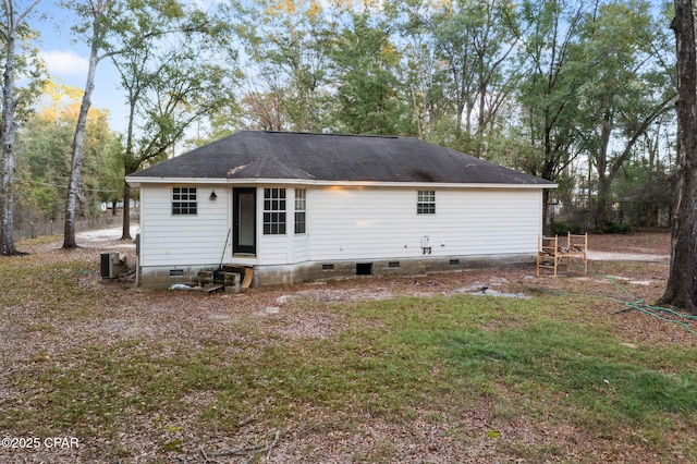 back of property featuring a yard