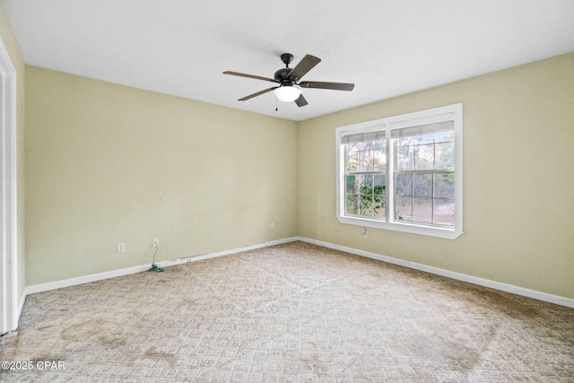 unfurnished room with ceiling fan and carpet flooring