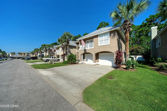 view of front of property featuring a balcony, a garage, and a front lawn