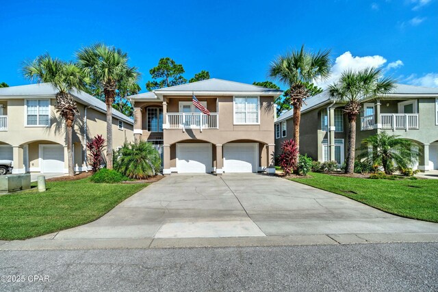 view of front facade with a garage, a balcony, and a front lawn