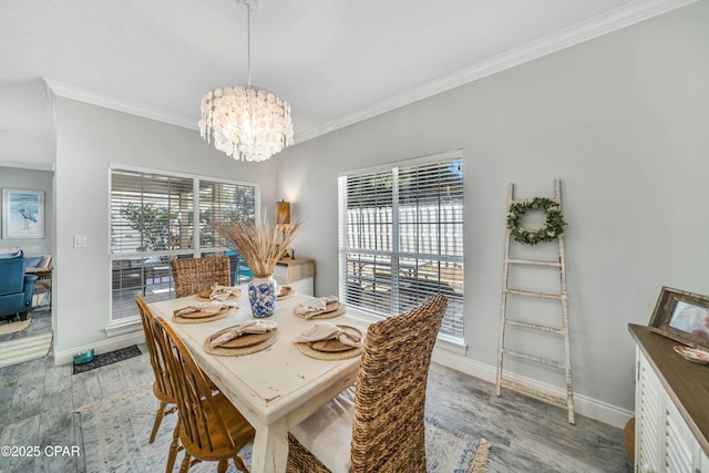 dining room with light wood-type flooring, a notable chandelier, and ornamental molding