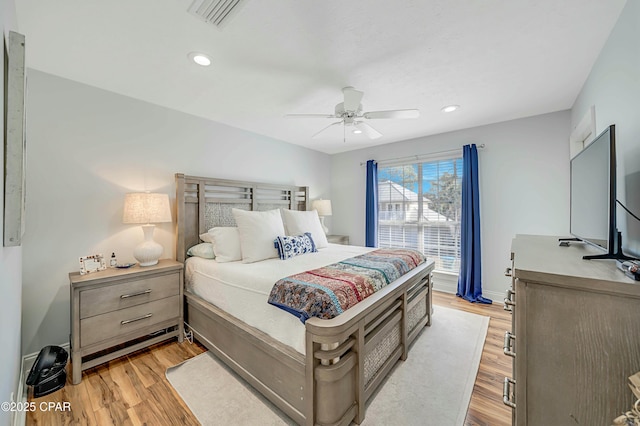 bedroom featuring ceiling fan and light hardwood / wood-style flooring