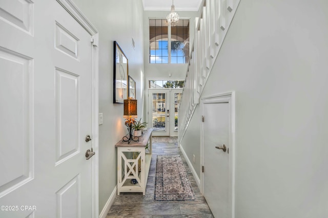 interior space with an inviting chandelier, a high ceiling, and ornamental molding