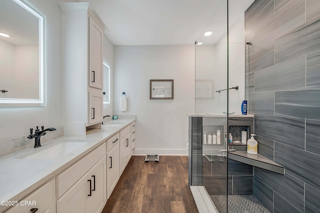 bathroom featuring vanity, wood-type flooring, and a shower with shower door