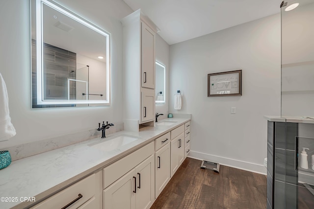 bathroom with vanity, hardwood / wood-style floors, and an enclosed shower