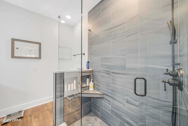 bathroom with a shower with shower door