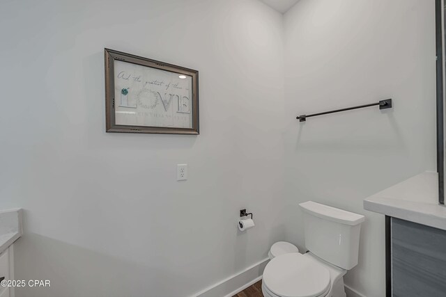 bathroom featuring vanity and toilet