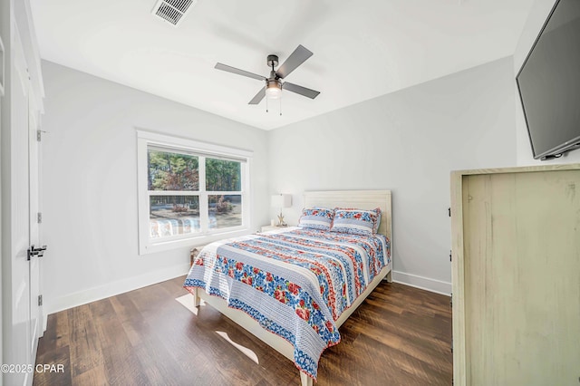 bedroom featuring dark hardwood / wood-style flooring and ceiling fan