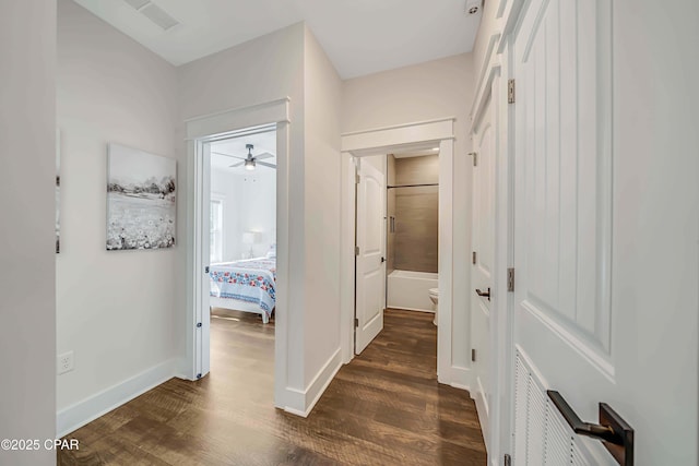 hallway with dark hardwood / wood-style flooring