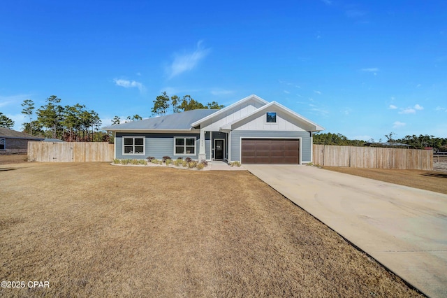 ranch-style house featuring a garage and a front yard