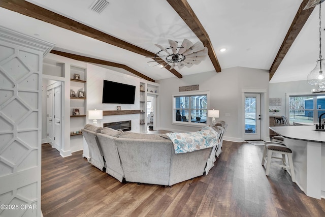 living room with ceiling fan, dark hardwood / wood-style floors, lofted ceiling with beams, and built in features