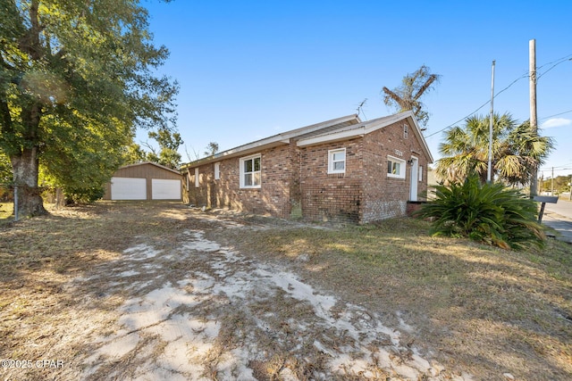 view of home's exterior with a garage and an outdoor structure