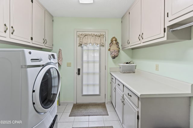 laundry room with cabinets, light tile patterned floors, and washer / dryer