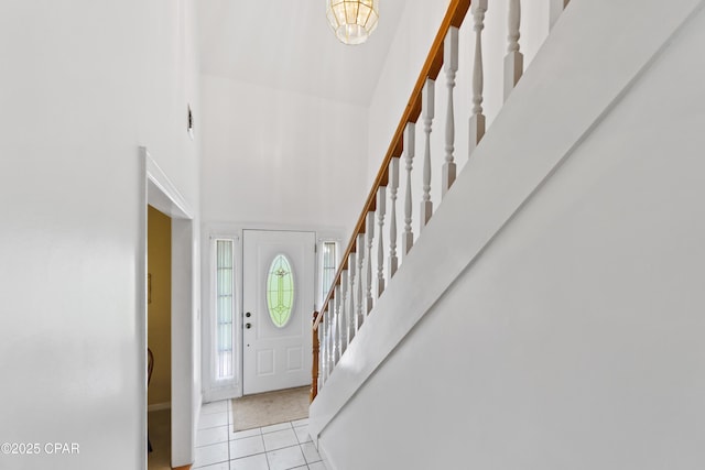 tiled entrance foyer featuring a high ceiling