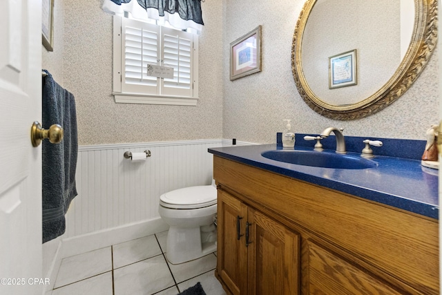 bathroom featuring toilet, tile patterned flooring, and vanity