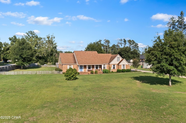 ranch-style home featuring a front lawn