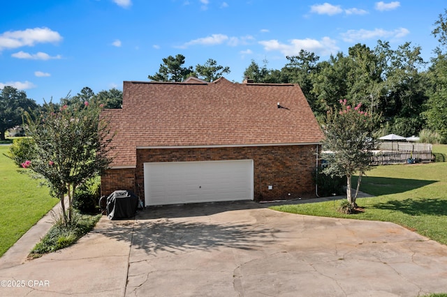 view of property exterior featuring a garage and a lawn