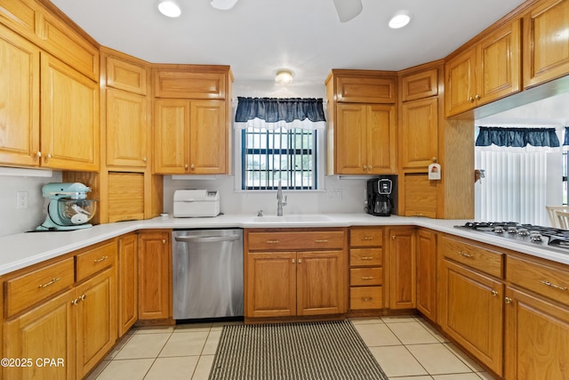 kitchen with light tile patterned floors, sink, stainless steel dishwasher, and gas stovetop