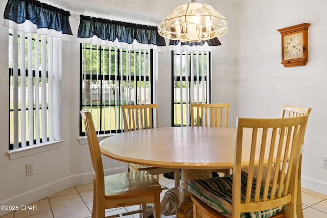 tiled dining area with a chandelier