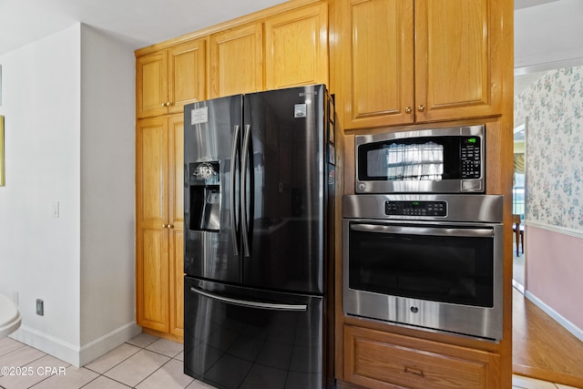 kitchen featuring light tile patterned floors and stainless steel appliances