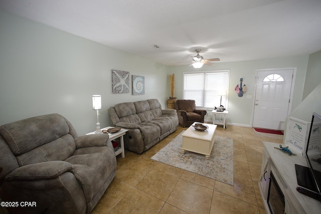 living room with ceiling fan and light tile patterned flooring