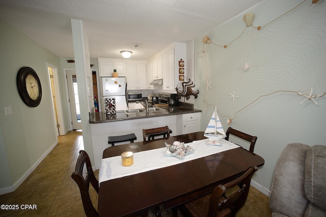 tiled dining area featuring sink