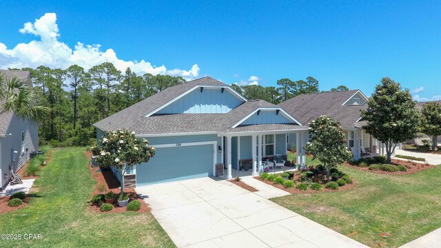 view of front facade with a garage, a front lawn, and a porch