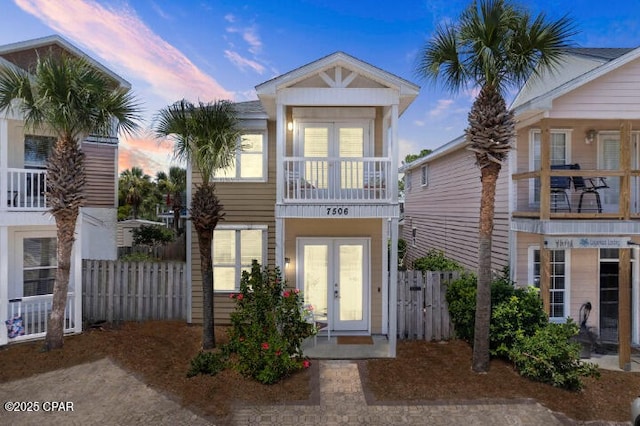 view of front of home featuring a balcony and french doors