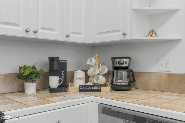 details featuring white cabinetry, dishwashing machine, and tile counters