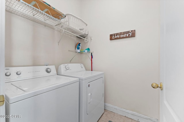 laundry room with light tile patterned flooring and washer and dryer