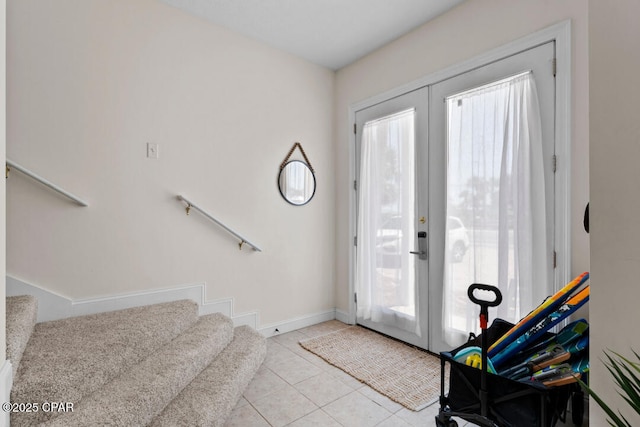 entryway featuring light tile patterned floors and french doors