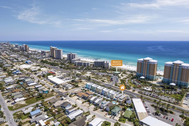 birds eye view of property with a water view and a view of the beach