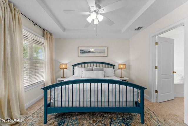 tiled bedroom featuring a tray ceiling and ceiling fan