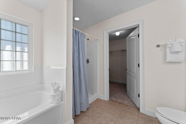 bathroom with toilet, separate shower and tub, and tile patterned flooring