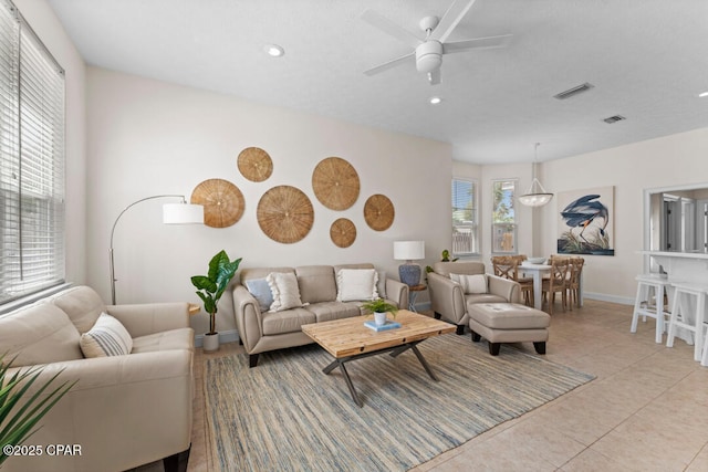 living room featuring ceiling fan and light tile patterned floors