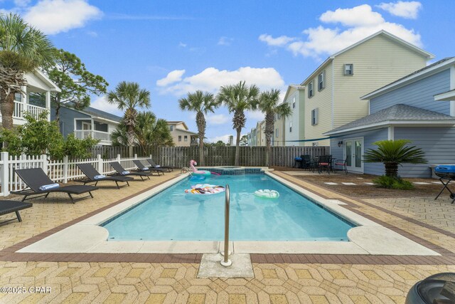 view of pool featuring an in ground hot tub and a patio area