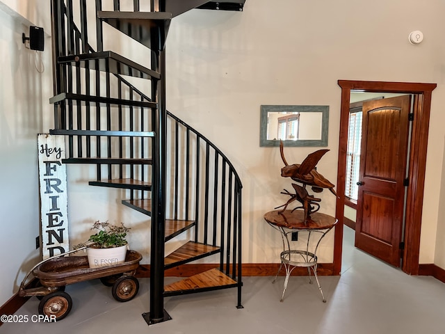 stairway featuring baseboards