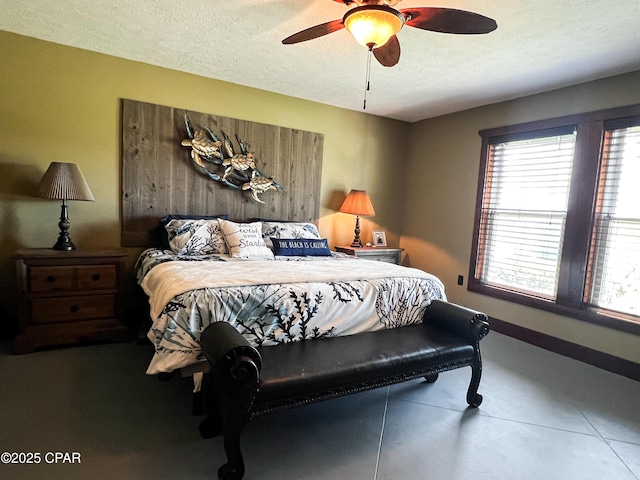 bedroom featuring a textured ceiling, multiple windows, ceiling fan, and finished concrete floors