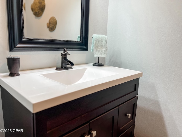 bathroom featuring a textured wall and vanity